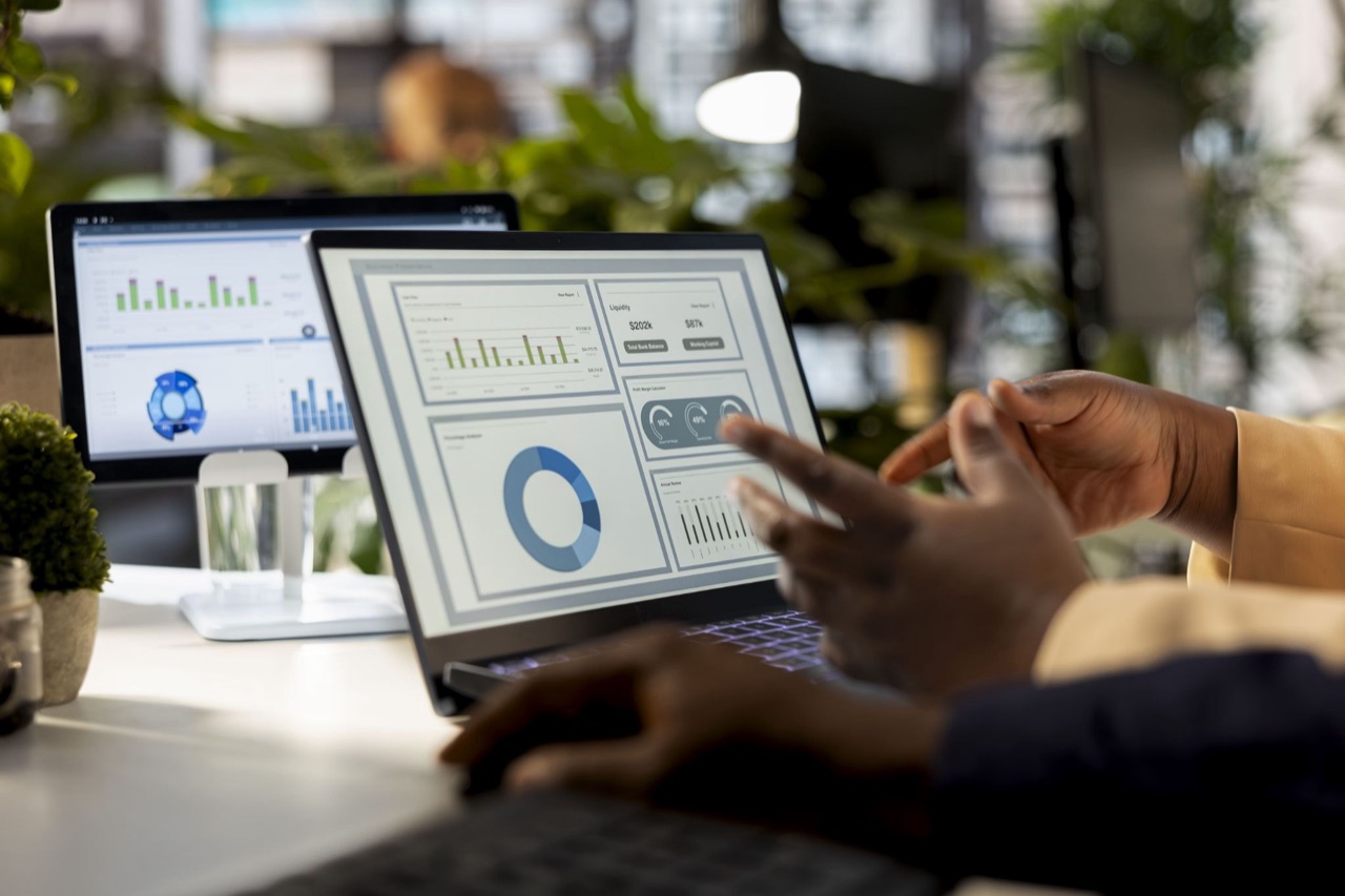 Close-up of an ERP finance dashboard showing cash flow, liquidity and profit margin reports on a laptop